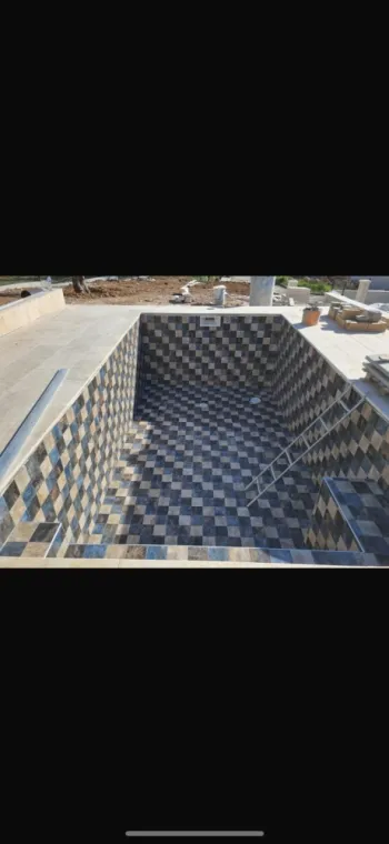 Piscine en carrelage avec motif de différentes couleurs 